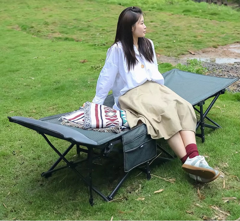 Heavy-duty folding camp cot in outdoor use